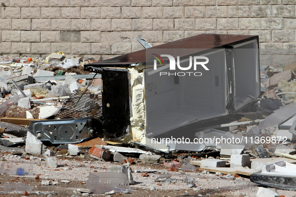 A broken fridge is lying on the ground outside the apartment block damaged by the June 28 Russian missile attack in Dnipro, Ukraine, on June...