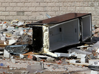 A broken fridge is lying on the ground outside the apartment block damaged by the June 28 Russian missile attack in Dnipro, Ukraine, on June...