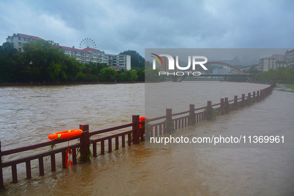 Part of the walking path is flooding as the water level of Yaqian River is rising due to heavy rainfall in Anqing, China, on June 29, 2024. 