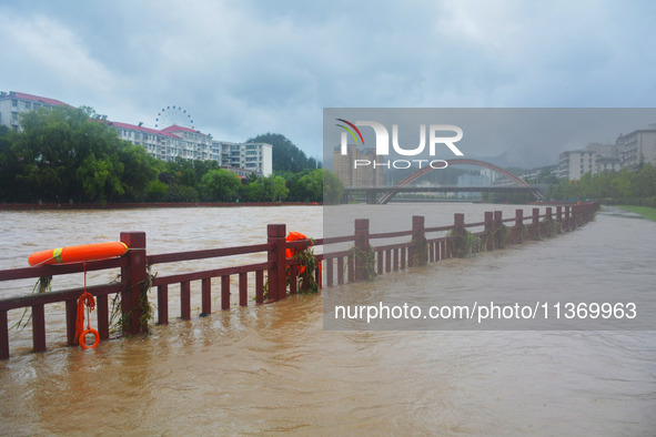 Part of the walking path is flooding as the water level of Yaqian River is rising due to heavy rainfall in Anqing, China, on June 29, 2024. 