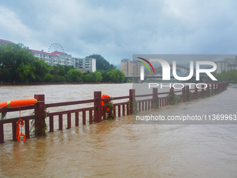 Part of the walking path is flooding as the water level of Yaqian River is rising due to heavy rainfall in Anqing, China, on June 29, 2024....