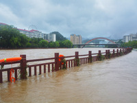 Part of the walking path is flooding as the water level of Yaqian River is rising due to heavy rainfall in Anqing, China, on June 29, 2024....