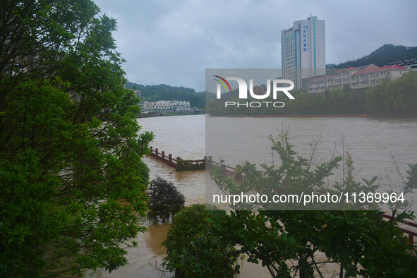 Part of the walking path is flooding as the water level of Yaqian River is rising due to heavy rainfall in Anqing, China, on June 29, 2024. 