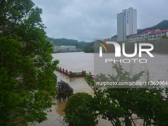 Part of the walking path is flooding as the water level of Yaqian River is rising due to heavy rainfall in Anqing, China, on June 29, 2024....