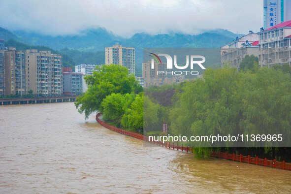 The water level of Yaqian River is rising after heavy rainfall in Anqing, China, on June 29, 2024. 