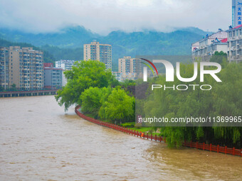 The water level of Yaqian River is rising after heavy rainfall in Anqing, China, on June 29, 2024. (