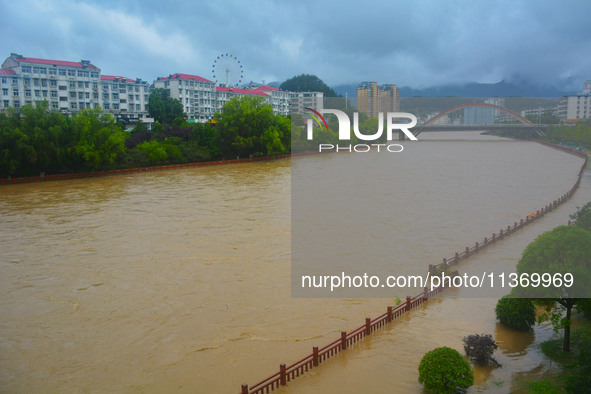 Part of the walking path is flooding as the water level of Yaqian River is rising due to heavy rainfall in Anqing, China, on June 29, 2024. 