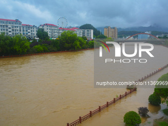 Part of the walking path is flooding as the water level of Yaqian River is rising due to heavy rainfall in Anqing, China, on June 29, 2024....