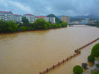 Part of the walking path is flooding as the water level of Yaqian River is rising due to heavy rainfall in Anqing, China, on June 29, 2024....