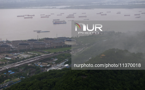 Ships are sailing on the Nanjing section of the Yangtze River in Nanjing, China, on June 29, 2024. 