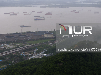 Ships are sailing on the Nanjing section of the Yangtze River in Nanjing, China, on June 29, 2024. (