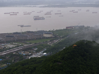 Ships are sailing on the Nanjing section of the Yangtze River in Nanjing, China, on June 29, 2024. (