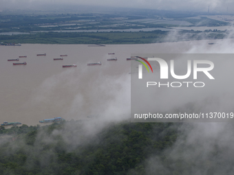 Ships are sailing on the Nanjing section of the Yangtze River in Nanjing, China, on June 29, 2024. (