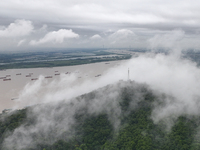 Ships are sailing on the Nanjing section of the Yangtze River in Nanjing, China, on June 29, 2024. (