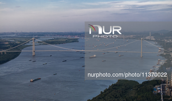 Ships are sailing on the Nanjing section of the Yangtze River in Nanjing, China, on June 29, 2024. 