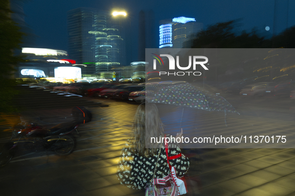 A woman holds an umbrella during a rain storm in Warsaw, Poland on 28 June, 2024. 