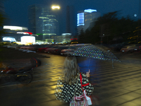 A woman holds an umbrella during a rain storm in Warsaw, Poland on 28 June, 2024. (