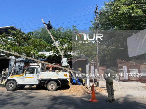 Workers are installing utility poles to support power lines in Kottarakkara, Kollam, Kerala, India, on April 06, 2024. 