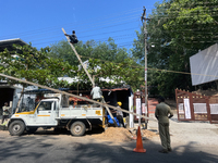 Workers are installing utility poles to support power lines in Kottarakkara, Kollam, Kerala, India, on April 06, 2024. (