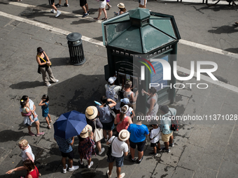 Tourists are queuing for heat at an Acea still or sparkling water dispenser in Rome, Italy, on June 29, 2024. (