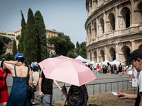 Tourists are visiting the Colosseum area, where temperatures are reaching 36 degrees Celsius in Rome, Italy, on June 29, 2024. (