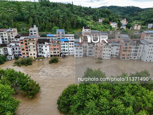 Aerial photo is showing houses and fields along the Wuyang River's Cenggong and Zhenyuan Yangping sections being flooded in Qiandongnan Pref...