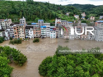 Aerial photo is showing houses and fields along the Wuyang River's Cenggong and Zhenyuan Yangping sections being flooded in Qiandongnan Pref...