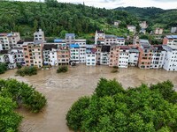 Aerial photo is showing houses and fields along the Wuyang River's Cenggong and Zhenyuan Yangping sections being flooded in Qiandongnan Pref...