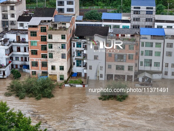 Aerial photo is showing houses and fields along the Wuyang River's Cenggong and Zhenyuan Yangping sections being flooded in Qiandongnan Pref...