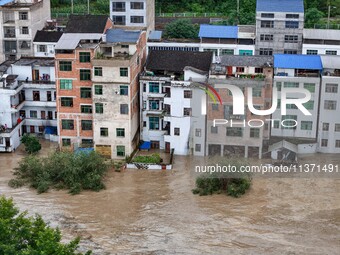 Aerial photo is showing houses and fields along the Wuyang River's Cenggong and Zhenyuan Yangping sections being flooded in Qiandongnan Pref...