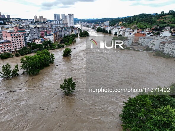 Aerial photo is showing houses and fields along the Wuyang River's Cenggong and Zhenyuan Yangping sections being flooded in Qiandongnan Pref...