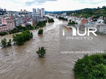 Aerial photo is showing houses and fields along the Wuyang River's Cenggong and Zhenyuan Yangping sections being flooded in Qiandongnan Pref...