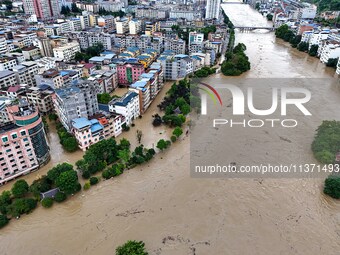 Aerial photo is showing houses and fields along the Wuyang River's Cenggong and Zhenyuan Yangping sections being flooded in Qiandongnan Pref...