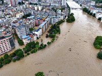 Aerial photo is showing houses and fields along the Wuyang River's Cenggong and Zhenyuan Yangping sections being flooded in Qiandongnan Pref...