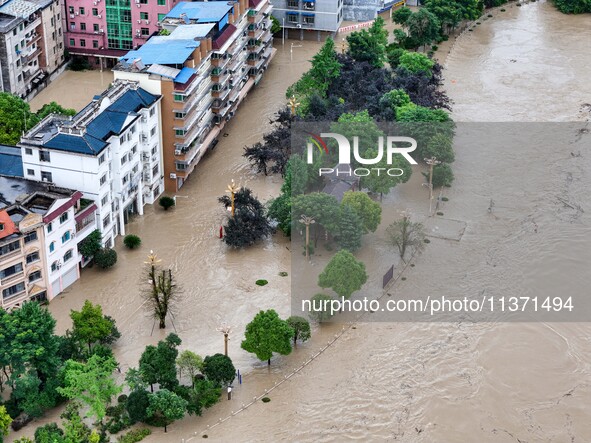 Aerial photo is showing houses and fields along the Wuyang River's Cenggong and Zhenyuan Yangping sections being flooded in Qiandongnan Pref...