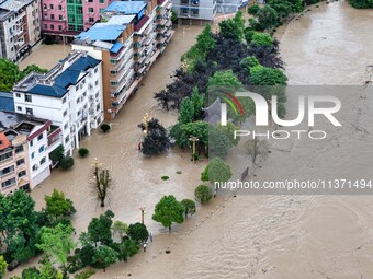 Aerial photo is showing houses and fields along the Wuyang River's Cenggong and Zhenyuan Yangping sections being flooded in Qiandongnan Pref...