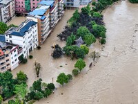 Aerial photo is showing houses and fields along the Wuyang River's Cenggong and Zhenyuan Yangping sections being flooded in Qiandongnan Pref...