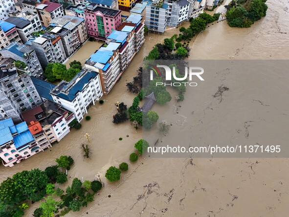 Aerial photo is showing houses and fields along the Wuyang River's Cenggong and Zhenyuan Yangping sections being flooded in Qiandongnan Pref...