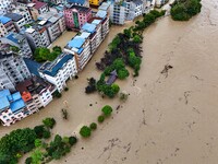 Aerial photo is showing houses and fields along the Wuyang River's Cenggong and Zhenyuan Yangping sections being flooded in Qiandongnan Pref...