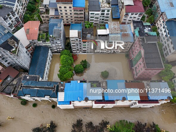 Aerial photo is showing houses and fields along the Wuyang River's Cenggong and Zhenyuan Yangping sections being flooded in Qiandongnan Pref...