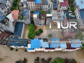 Aerial photo is showing houses and fields along the Wuyang River's Cenggong and Zhenyuan Yangping sections being flooded in Qiandongnan Pref...