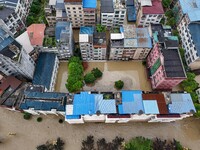 Aerial photo is showing houses and fields along the Wuyang River's Cenggong and Zhenyuan Yangping sections being flooded in Qiandongnan Pref...