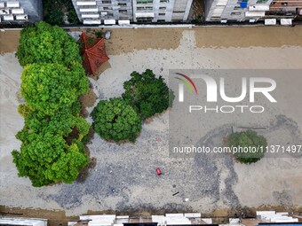 Aerial photo is showing houses and fields along the Wuyang River's Cenggong and Zhenyuan Yangping sections being flooded in Qiandongnan Pref...