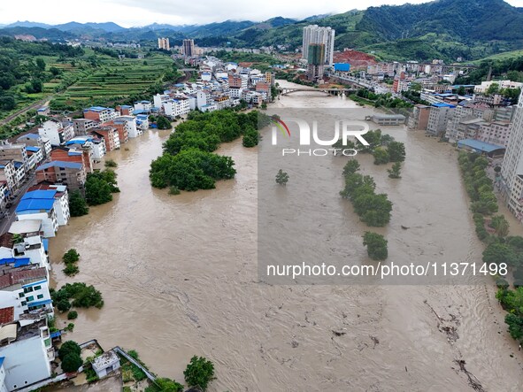 Aerial photo is showing houses and fields along the Wuyang River's Cenggong and Zhenyuan Yangping sections being flooded in Qiandongnan Pref...