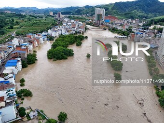 Aerial photo is showing houses and fields along the Wuyang River's Cenggong and Zhenyuan Yangping sections being flooded in Qiandongnan Pref...