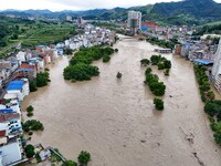 Aerial photo is showing houses and fields along the Wuyang River's Cenggong and Zhenyuan Yangping sections being flooded in Qiandongnan Pref...