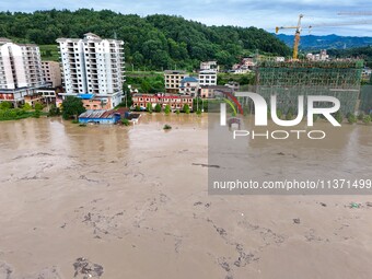 Aerial photo is showing houses and fields along the Wuyang River's Cenggong and Zhenyuan Yangping sections being flooded in Qiandongnan Pref...