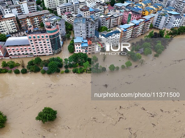 Aerial photo is showing houses and fields along the Wuyang River's Cenggong and Zhenyuan Yangping sections being flooded in Qiandongnan Pref...