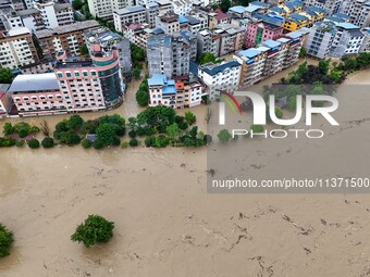 Aerial photo is showing houses and fields along the Wuyang River's Cenggong and Zhenyuan Yangping sections being flooded in Qiandongnan Pref...