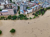 Aerial photo is showing houses and fields along the Wuyang River's Cenggong and Zhenyuan Yangping sections being flooded in Qiandongnan Pref...